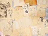a lot of drawings on a table with a book