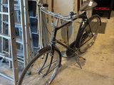 a bike that is leaning against a rack in a garage