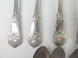 five spoons and two spoons on a white surface