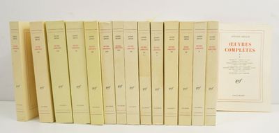 several books are lined up in a row on a white surface