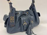 a blue handbag with a tag and tassel on it