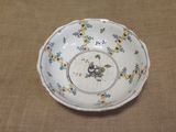 a white bowl with blue and yellow flowers on it