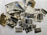 a pile of old black and white photos on a table