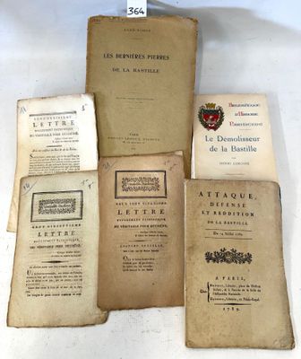 several old books sitting on top of each other on a table