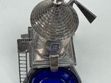 a blue glass bowl with a silver windmill on it
