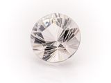 a close up of a diamond on a white surface