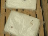two bags of cheese sitting on top of a wooden pallet