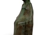 sculpture of a woman sitting on a chair