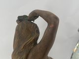 a statue of a woman with a bird on her head