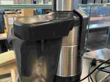 a silver and black blender sitting on top of a metal counter
