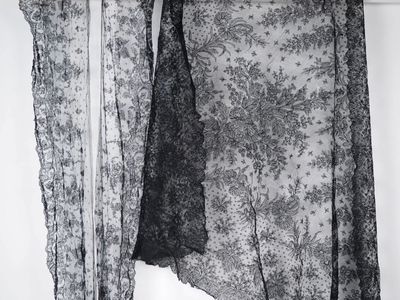 a black and white photo of a dress hanging on a clothes rack