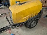 a small trailer with a yellow cover on it in a garage