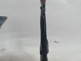 a statue of a man holding a knife in the snow