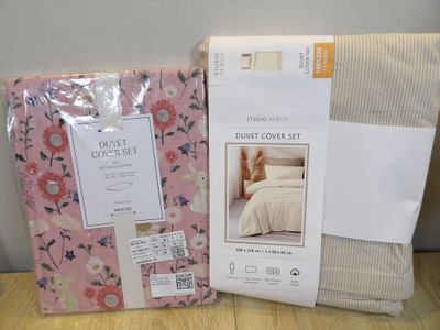 two sheets and a pillow on the table