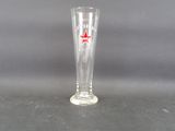 a glass with a red star on it on a table