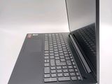 a laptop that is open on a white surface