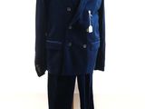 a suit on a mannequin stand in front of a window