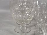 six wine glasses sitting on a table next to each other