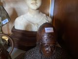 a bust of a man and a bust of a woman on a shelf