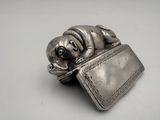 a silver purse with a dog on top of it