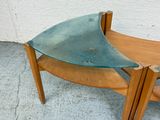 a wooden bench with a glass top on the sidewalk