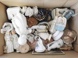 a cardboard box filled with assorted items and figurines