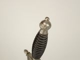 a silver and black sword with a skull on top of it