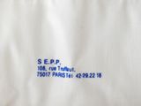 a close up of a white shirt with blue writing on it