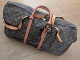 a brown and black duffel bag on the floor