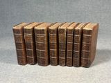 a set of six old books sitting on top of each other