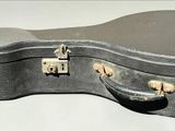 a guitar case sitting on top of a white table