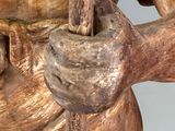 a statue of a man holding a stick in his hand