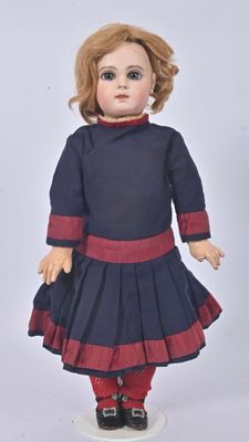 an image of a doll of a girl in a blue dress and red tights