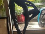 a statue of a man holding a surfboard in front of a window