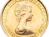 an image of a close up of a gold coin with a woman ' s face on it