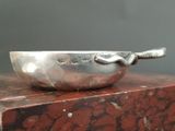 a silver bowl with a spoon on top of it