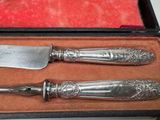 two knives in a box on a table