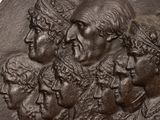 a close up of a plaque with a group of people on it