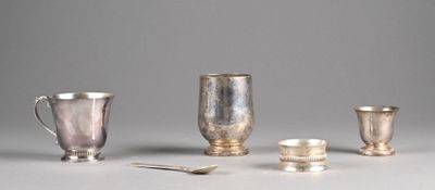 four silver cups and spoons sitting on a table