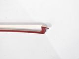 a close up of a red handle on a white car