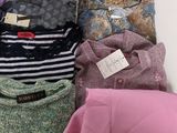 a lot of clothes that are sitting on a table