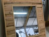 two mirrors sitting on the wall next to each other