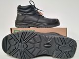 a pair of black work boots sitting on top of a box