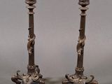 pair of antique bronze candlesticks with lion heads on the bases