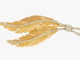 an image of a close up of a leaf brooch on a white background