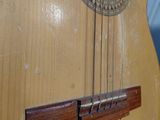 a close up of a guitar that is on a table