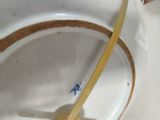 a white bowl with a wooden handle in it