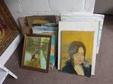 a pile of paintings and a painting on the floor