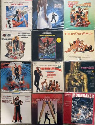 many different movie posters on a wall in a room