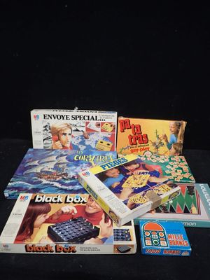 une pile de jeux de société posée sur une table noire